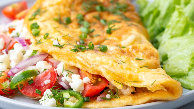 Omelet stuffed with cheese and veggies 