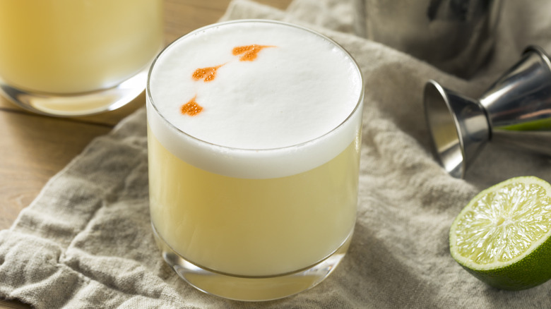 Yellow cocktail with egg white foam