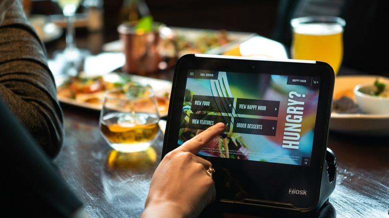 Person ordering on a Ziosk tablet