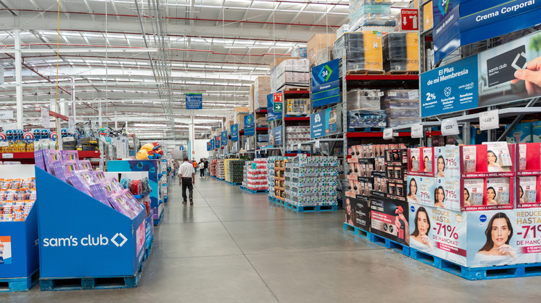 A Sam's Club aisle with views of more aisles and a Sam's Club-branded display rack