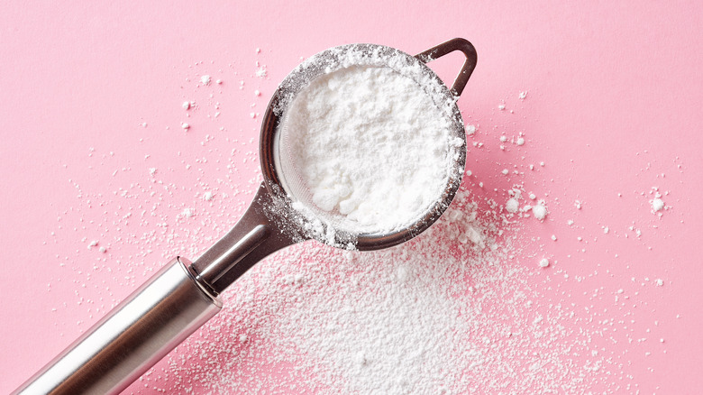 Superfine sugar in a sieve