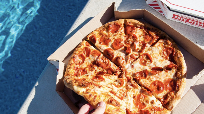 Domino's pepperoni pizza by the pool