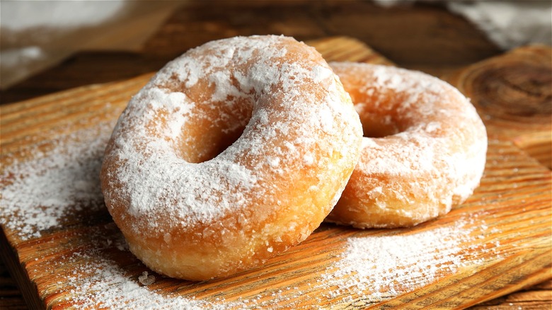 Two donuts with powdered sugar 
