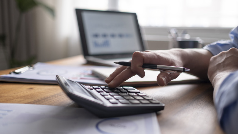 Hand using a calculator