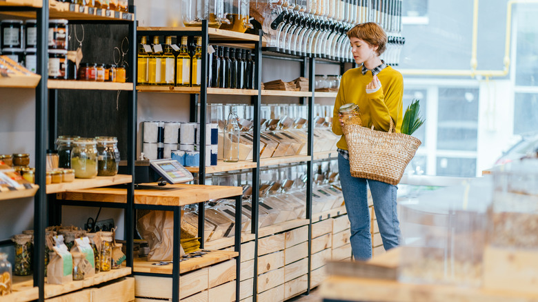 Woman standing by store shelves