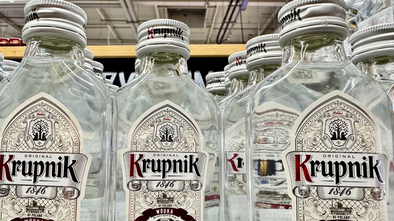 Several bottles of Polish Krupnik vodka on display in a store