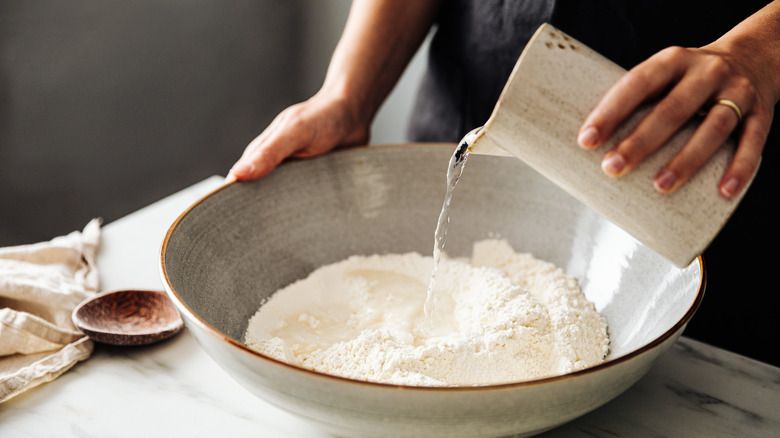 ceramic mixing bowl with flour and water