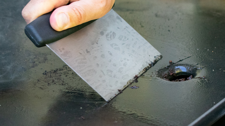 Using a grill scraper