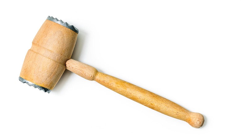 wooden meat tenderizer on white background