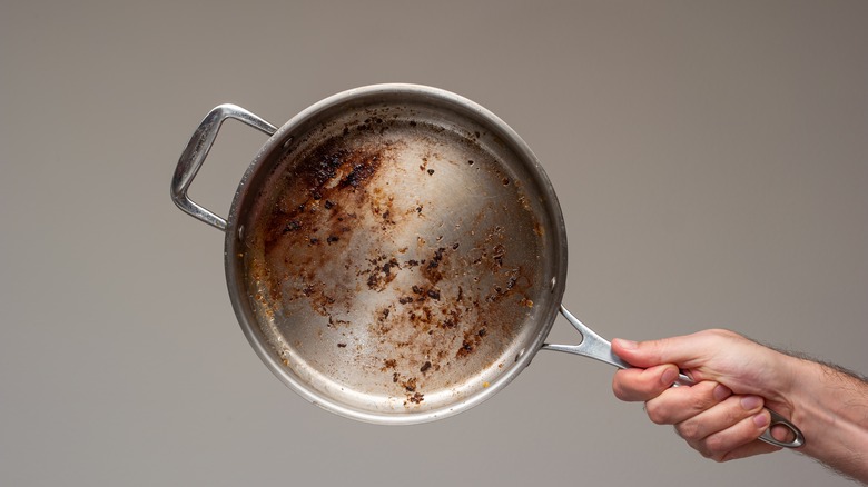 https://www.thedailymeal.com/img/gallery/how-to-clean-stainless-steel-pans-and-save-time-scrubbing/intro-1692994868.jpg
