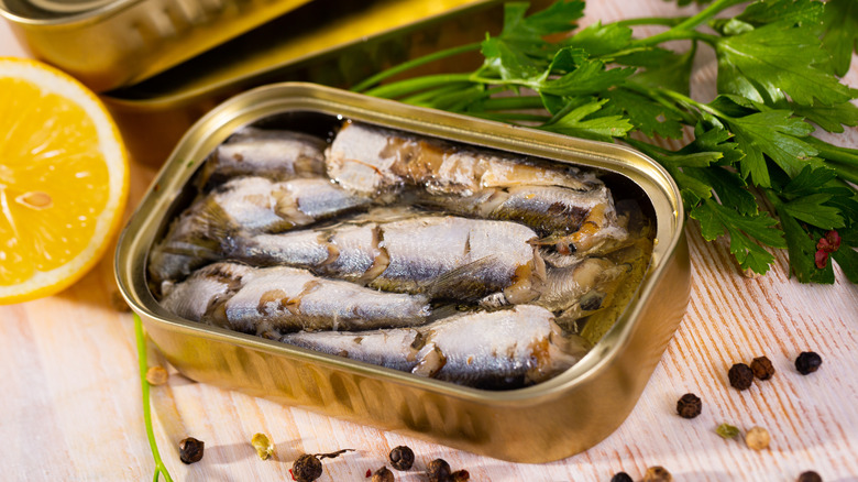 An open tin of sardines on a wooden table