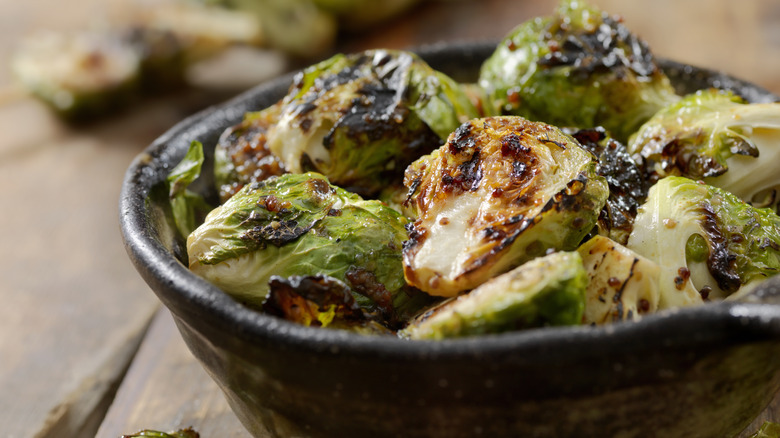roasted charred Brussel sprouts in black bowl