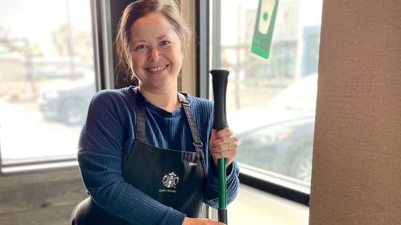 Starbucks employee wearing black apron