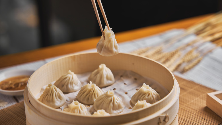 Soup dumplings served in a steamer basket