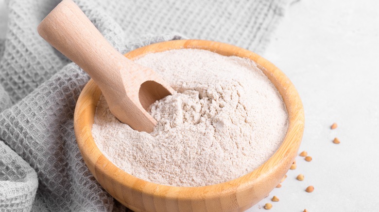bowl of flour with wooden spoon