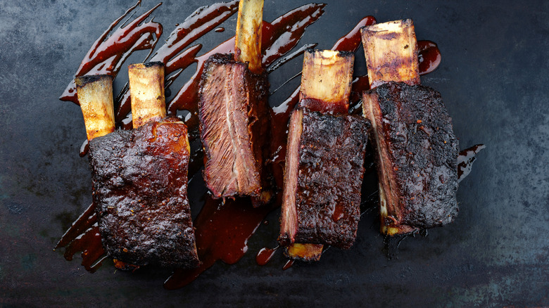 Beef short ribs on slate background with sauce