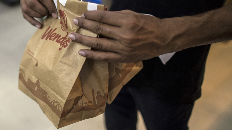 Person holding a wendy's bag