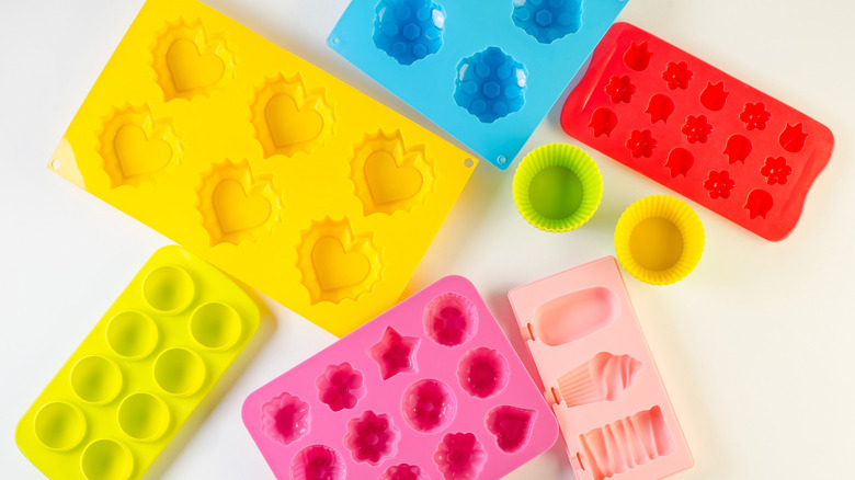 Various brightly-colored silicone molds on a white background