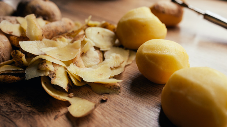 Peeled potatoes and skins