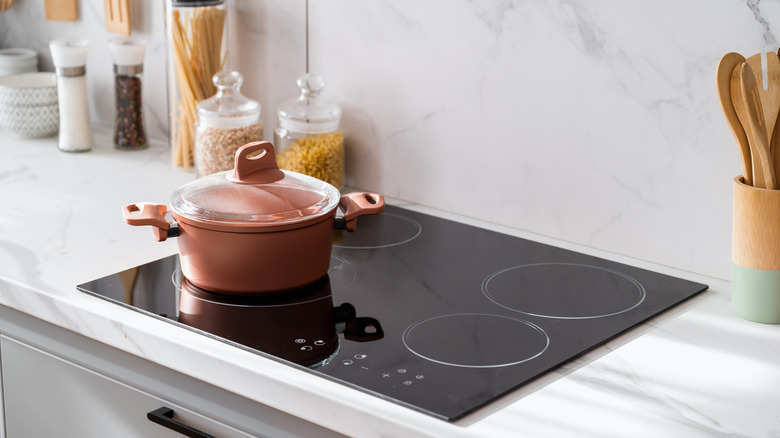 Glass stove-top with a pan