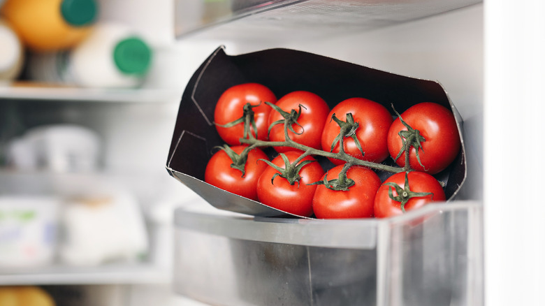 Vine tomatoes sit in a fridge