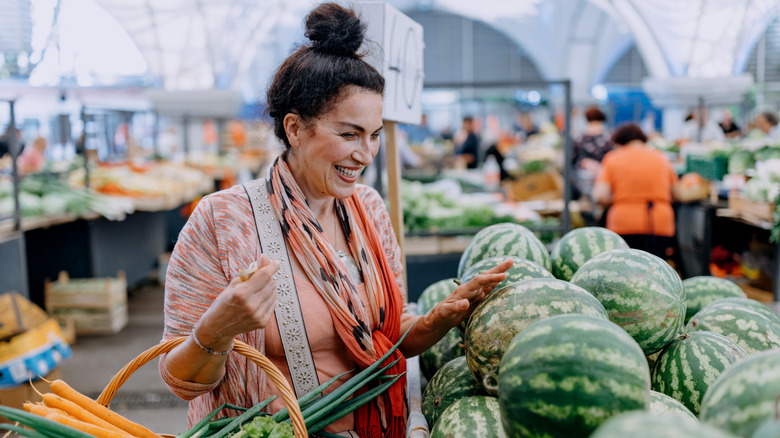 Woman touching a watermelon
