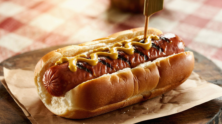 Grilled hot dog with mustard