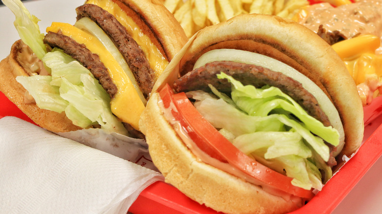Two burgers with fries in basket