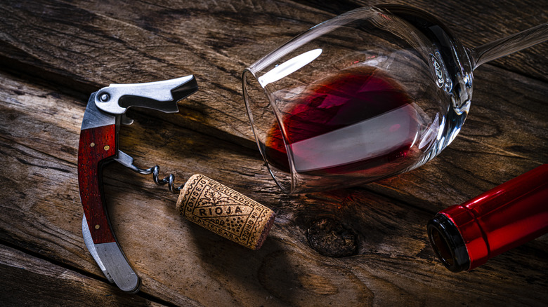 Wine glass and cork with corkscrew