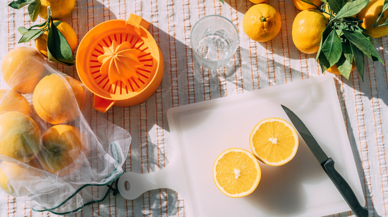 Fresh oranges placed on a choppping board.