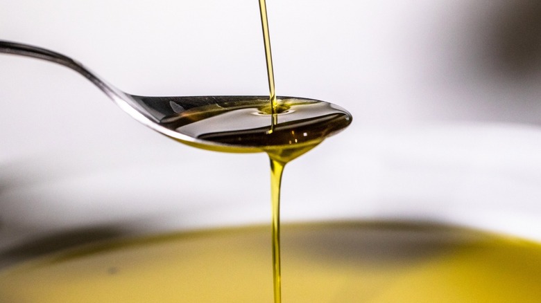 Oil drizzled from a spoon