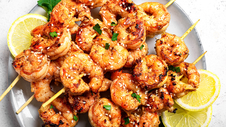 Close up of grilled shrimp on skewers on a plate