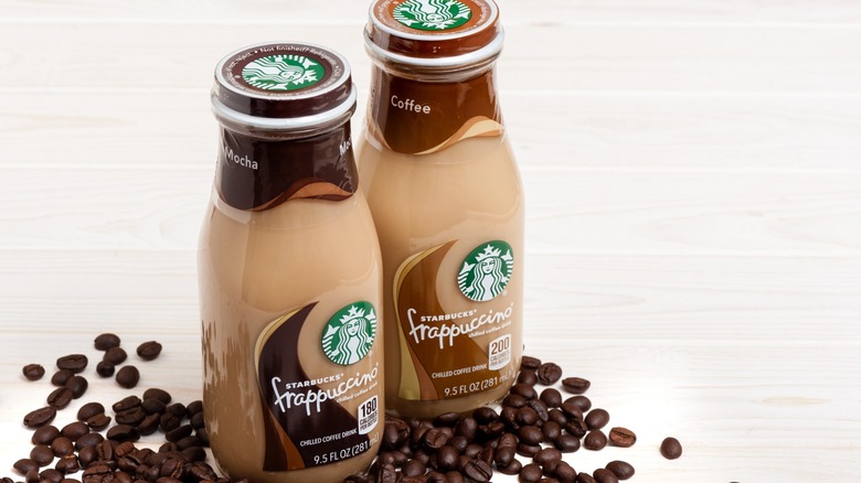 Two bottled Starbucks Frappuccinos with coffee beans