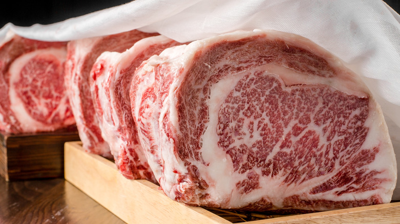 Wagyu beef placed on wooden trays.