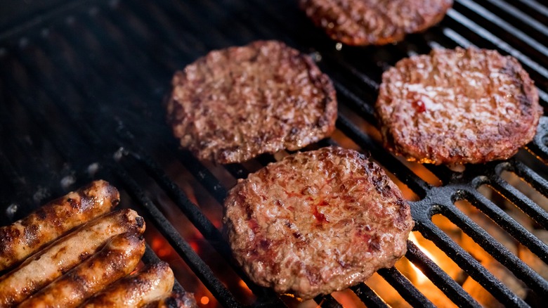 Burgers and sausages on grill