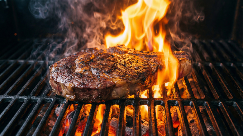 Steak on flaming grill