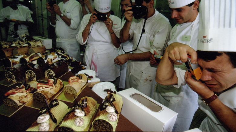 Chefs photograph elaborate cakes