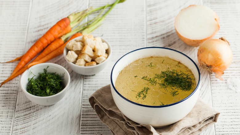 bowl of bone broth near vegetables