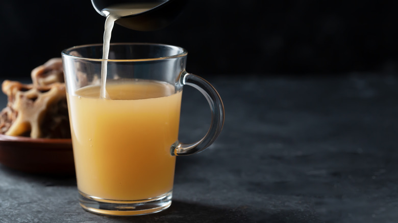 pouring bone broth into glass