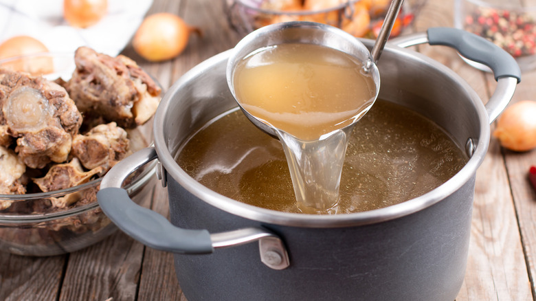 pot of bone broth with ladle