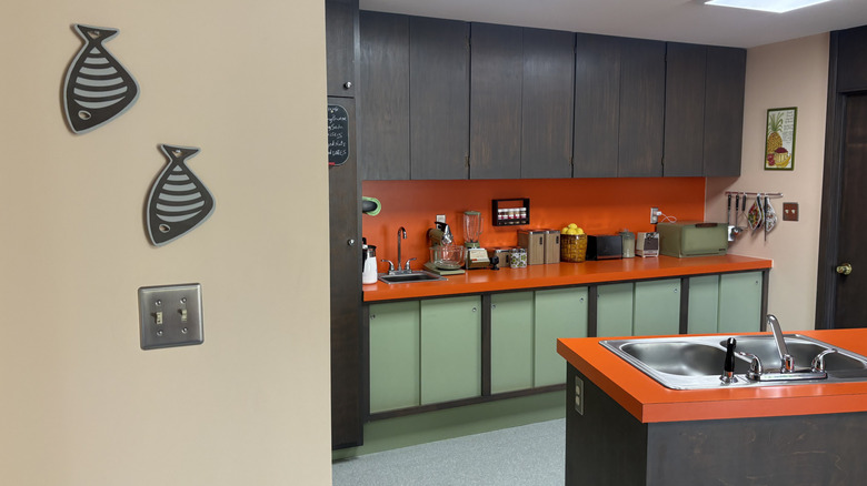 A wide shot of The Brady Bunch kitchen showing two fish ornaments hanging on the wall