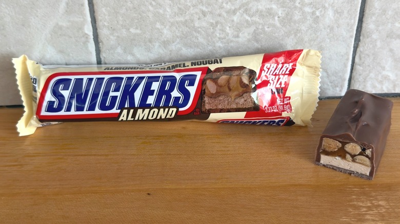 Almond Snickers bar with piece cut in half