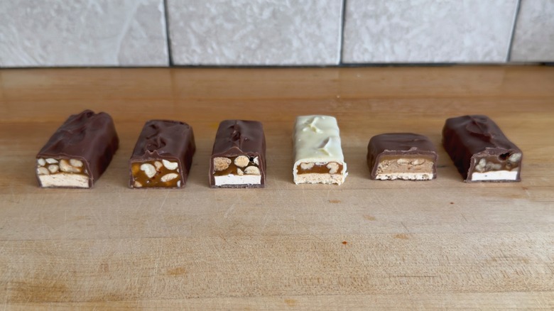 6 different flavors of Snickers bars cut in half
