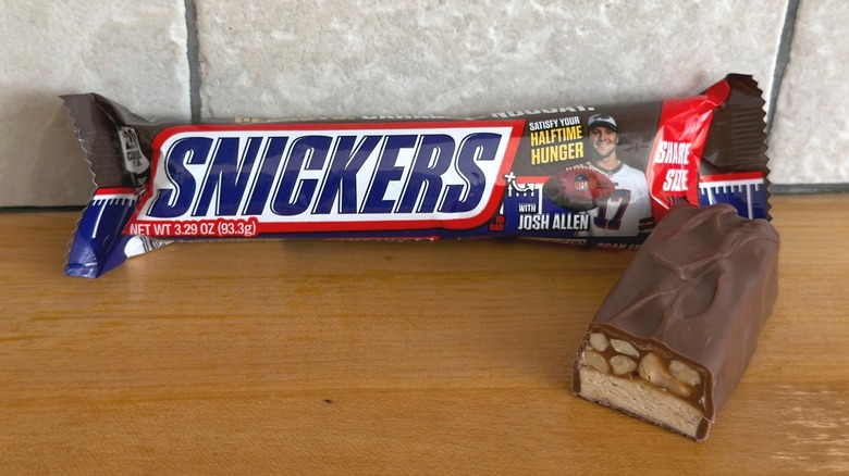 Original Snickers bar with piece cut in half