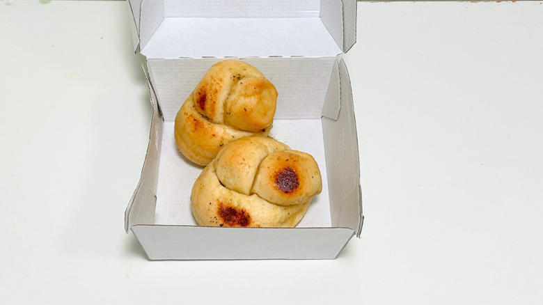 Close up of two Wawa Garlic Knots in a to-go container