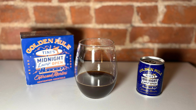 A package of Golden Rule next to a glass of espresso martini and a can of the drink against a brick backdrop