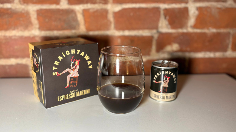 A package of Straightaway next to a glass of espresso martini and a can of the drink against a brick backdrop