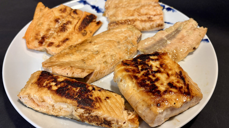 six pieces of cooked salmon on plate