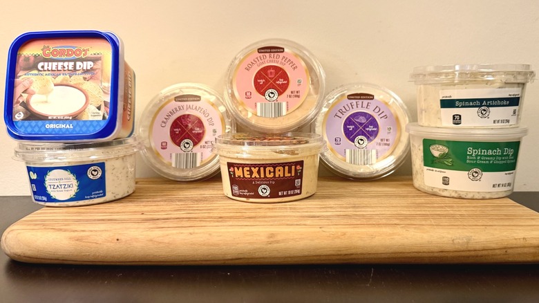 Aldi dips lined up against a wall