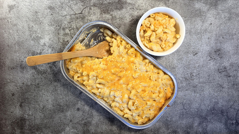 pan and bowl of baked macaroni and cheese